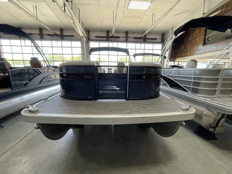 Pontoon boat on display at Hall's Sport Center, showcasing watercraft and boating accessories.