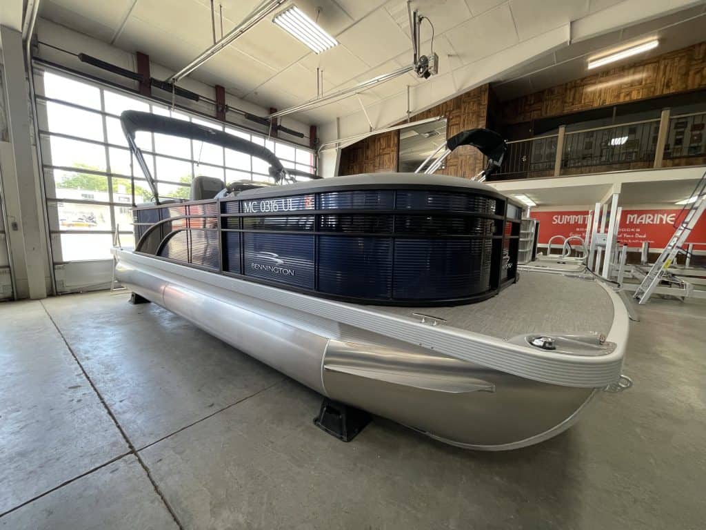 Pontoon boat showcased at Hall's Sport Center for water sports enthusiasts.
