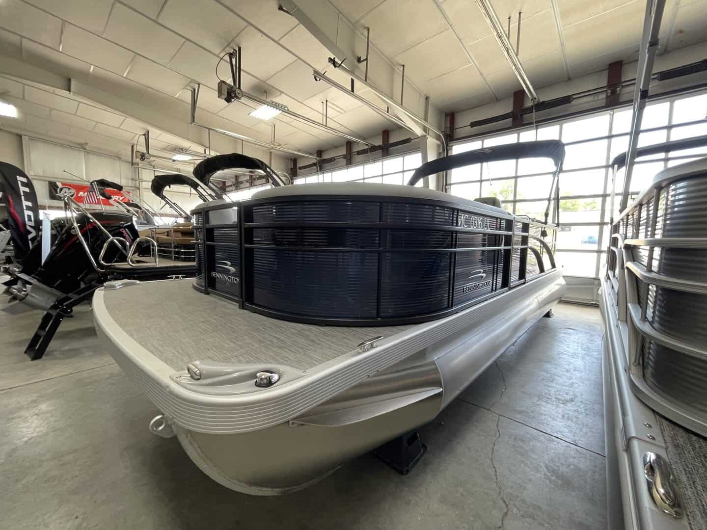 Pontoon boat displayed at Hall's Sport Center, showcasing premium watercraft and boating accessories.