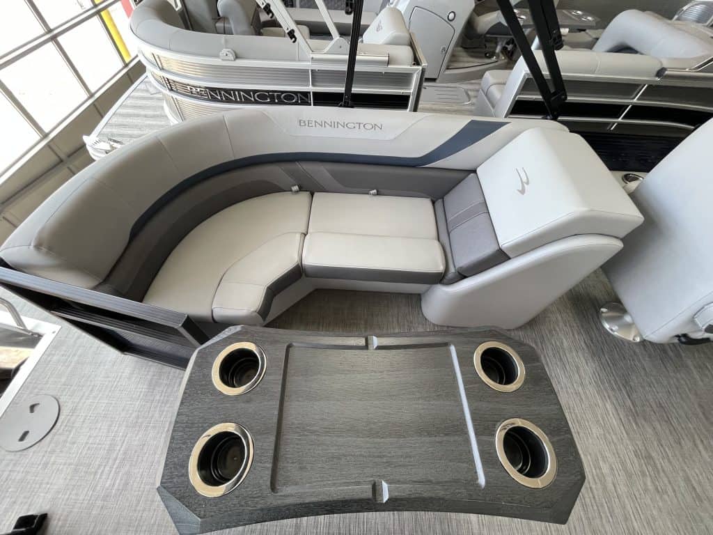 Bennington pontoon boat with comfortable seating and built-in cup holders at Hall's Sport Center.
