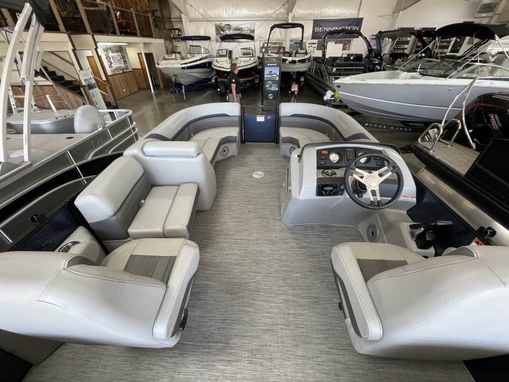 Boat showroom interior showcasing different models and seating arrangements.