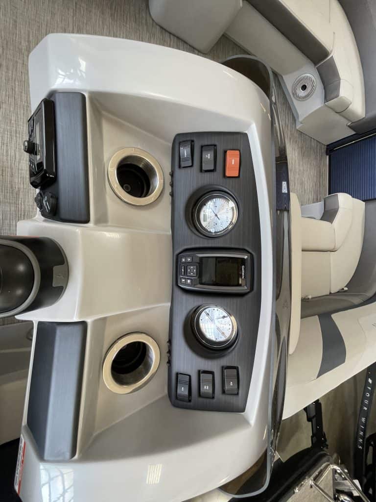 Golf cart dashboard with steering, gauges, and control switches at Hall's Sport Center.