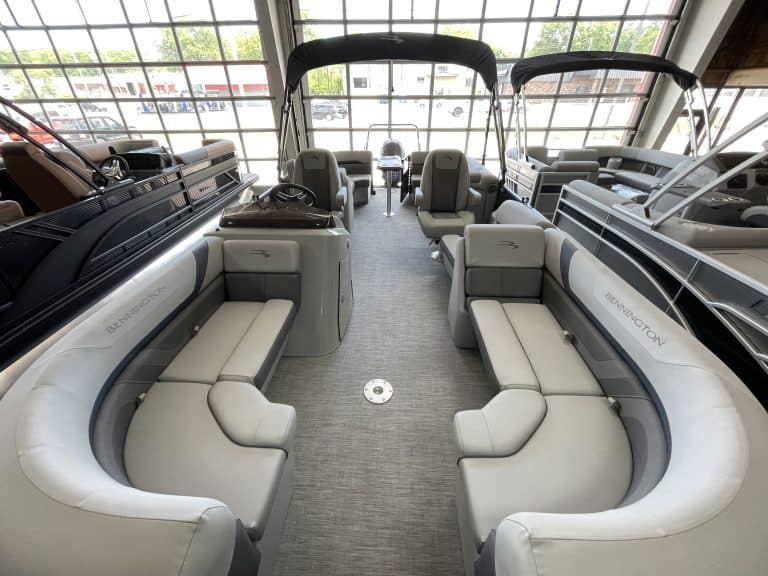 Luxury pontoon boat interior with seating and navigation controls at Hall's Sport Center.