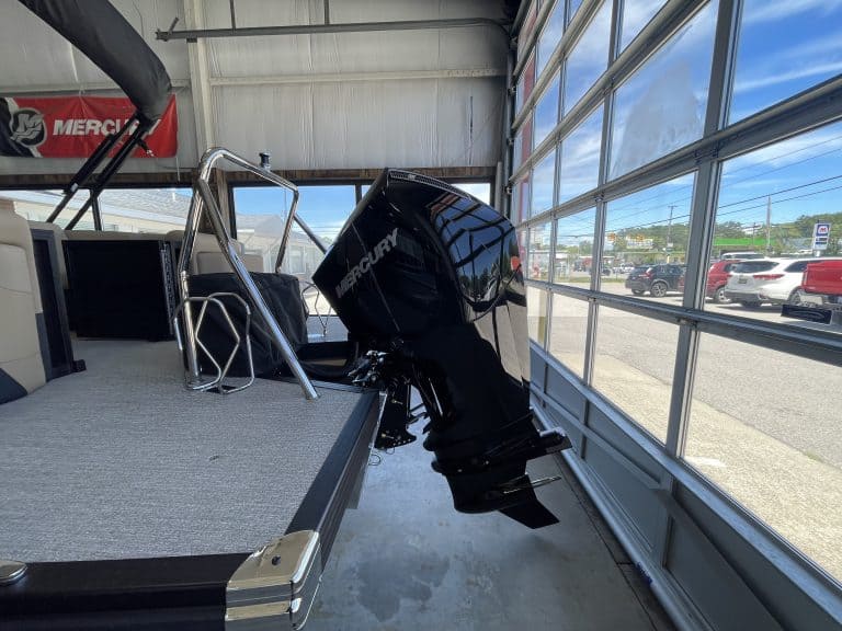 Outboard motor on boat at Hall's Sport Center, showcasing marine equipment.