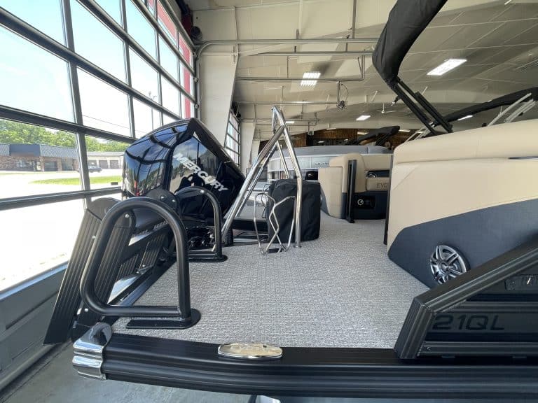 Indoor boat display at Hall's Sport Center with various boat models.