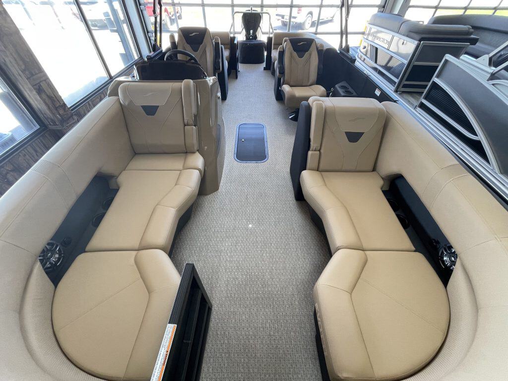 Elegant beige and black yacht seating with panoramic windows.