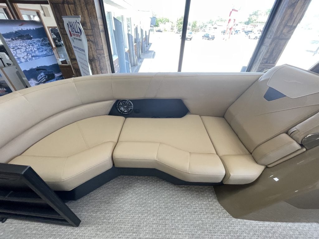 Comfortable cream-colored boat seating with a view of the showroom.