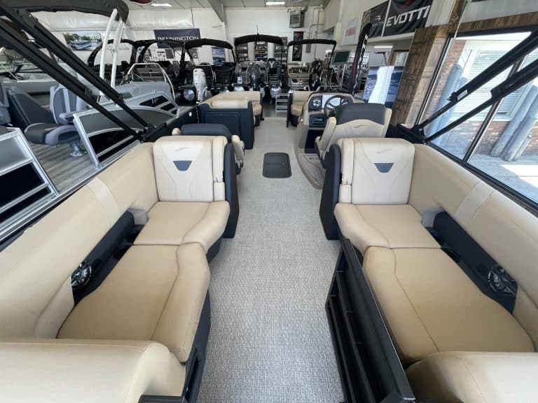 Luxury boat seating area at Hall's Sport Center with multiple boats on display.