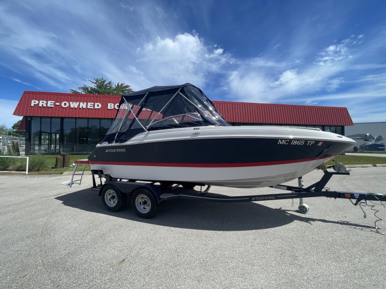 Pre-owned Four Winns 215 SUNDOWNER boat on trailer at Hall's Sport Center.