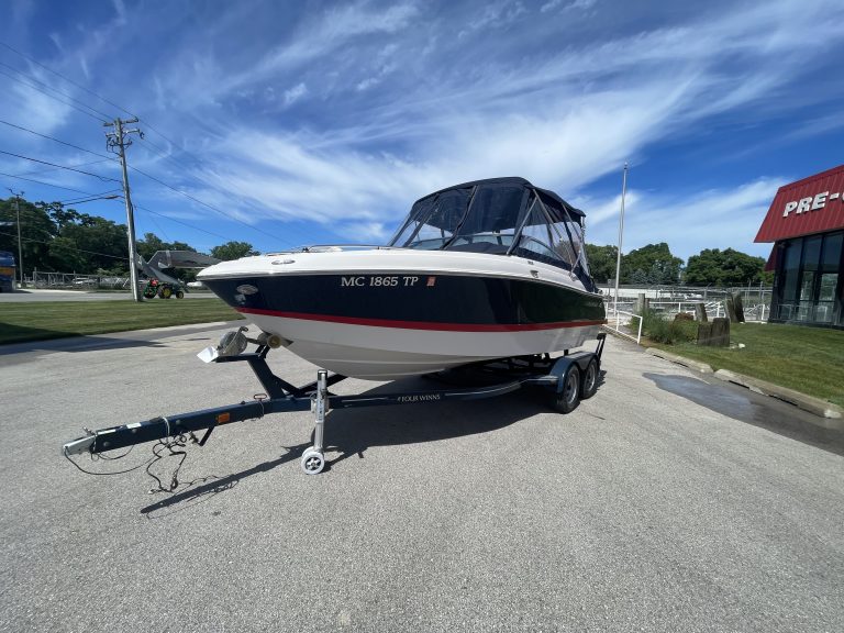Four Winns 215 SUNDOWNER boat on trailer at Hall's Sport Center.
