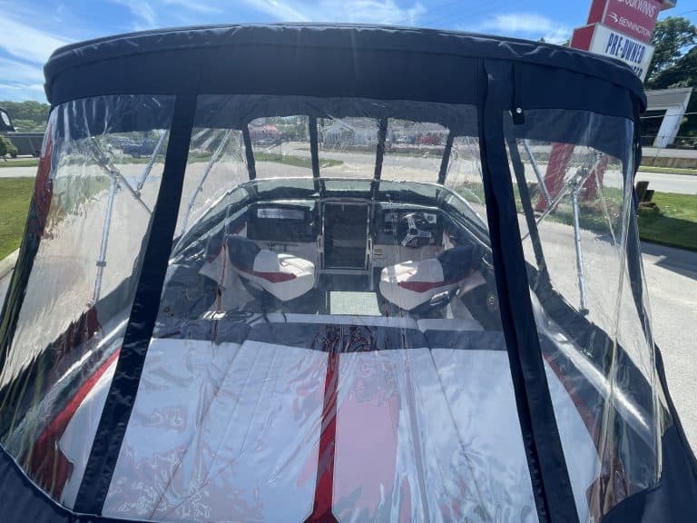 Boat with protective cover and clear windshield at Hall's Sport Center.