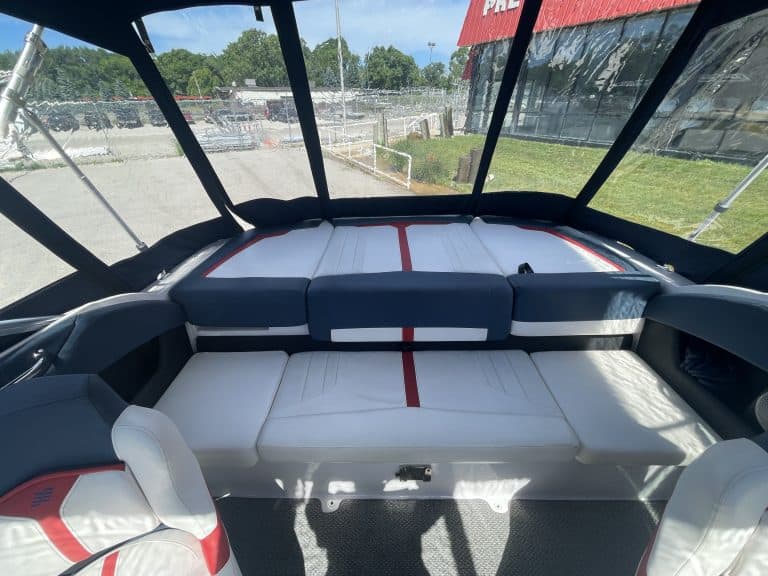 Interior view of a Four Winns 215 SUNDOWNER boat with seating and windshield.