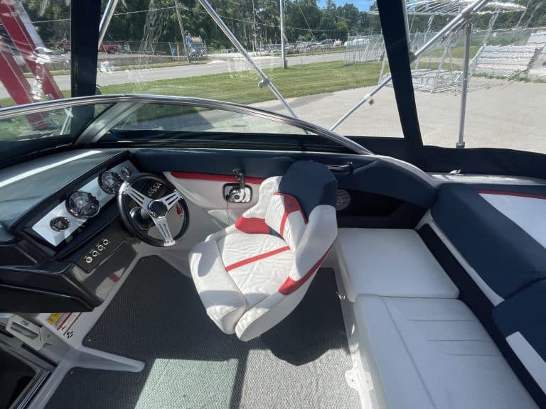 Boat cockpit with steering wheel and seating at Hall's Sport Center.