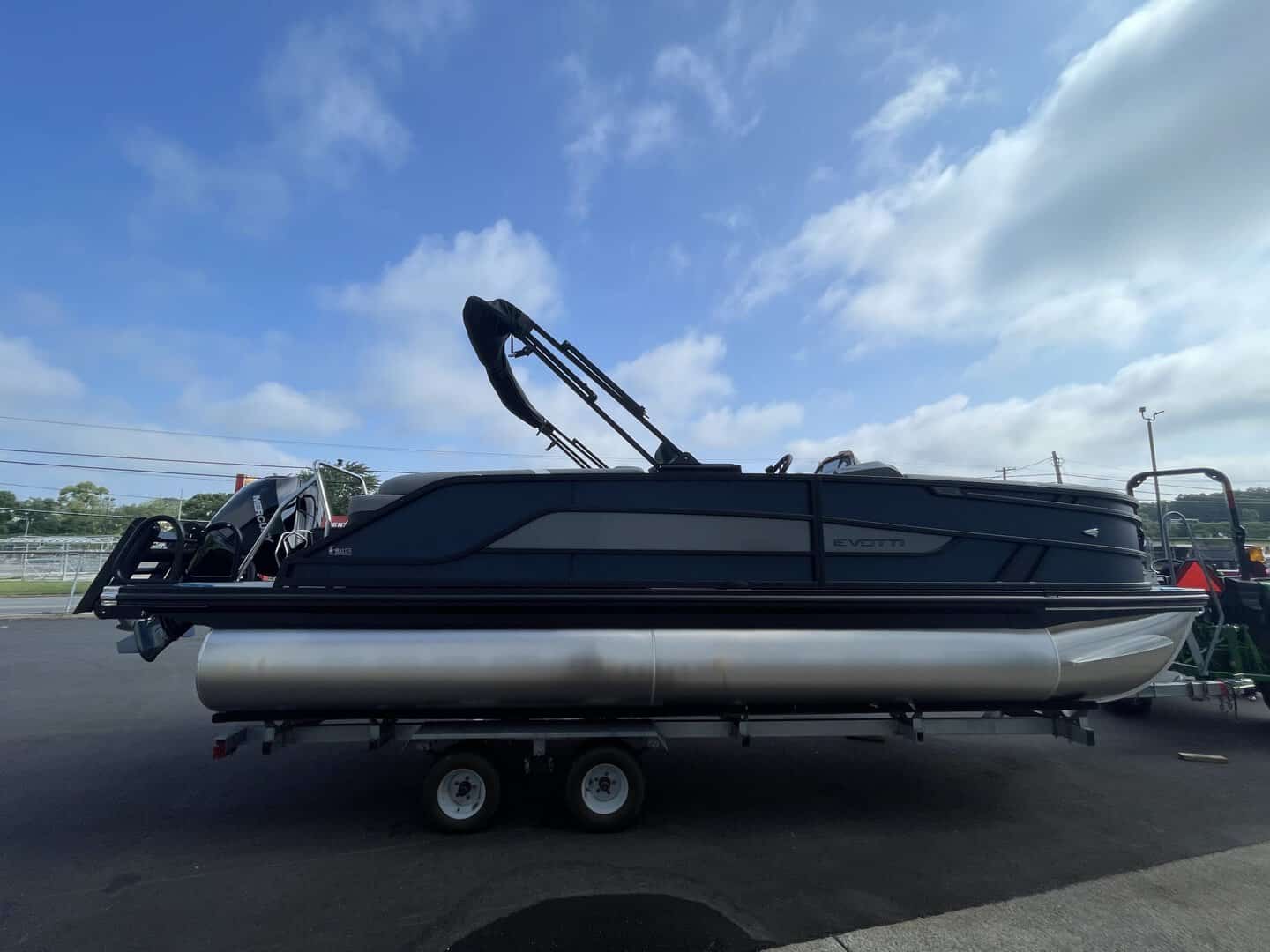Luxury pontoon boat on trailer at Hall's Sport Center.