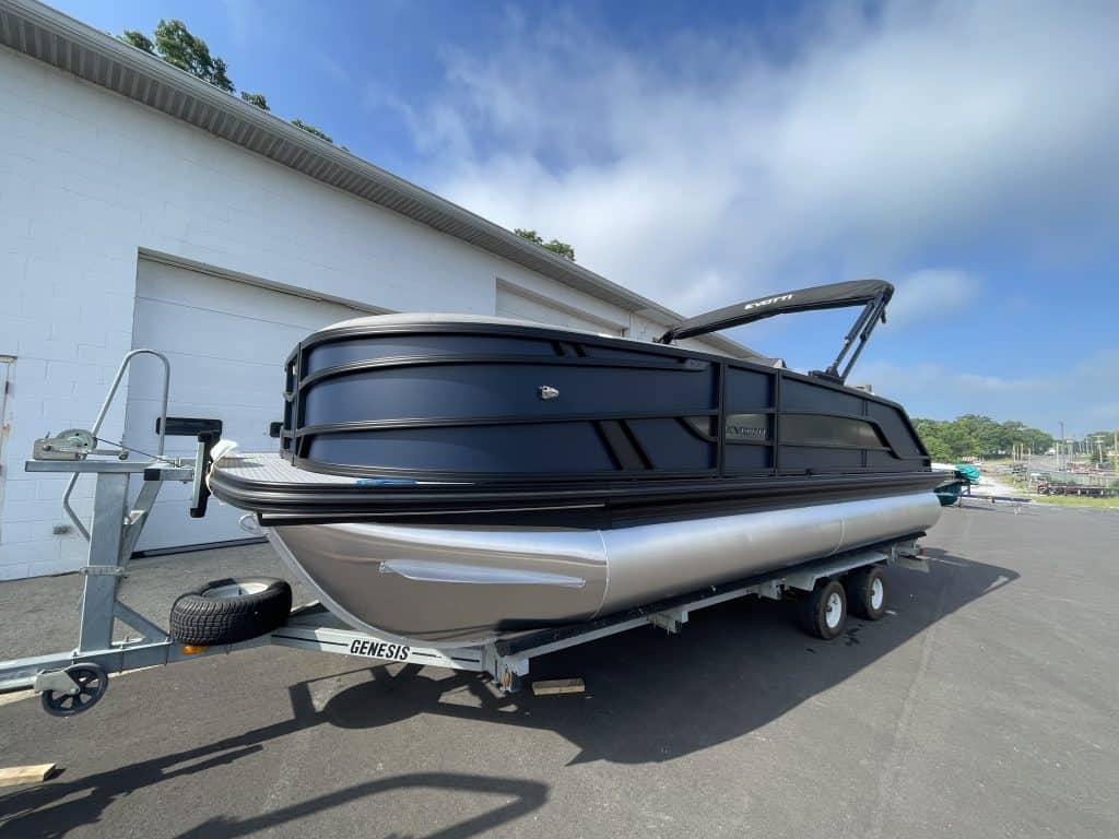 Luxury pontoon boat at Hall's Sport Center with sleek black design.