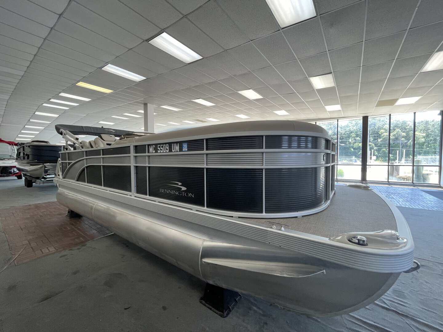 Bennington 21 SS pontoon boat inside Hall's Sport Center showroom.