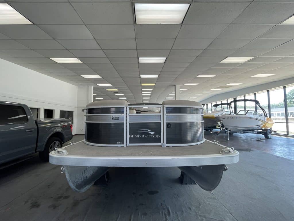 Bennington 21 SS pontoon boat inside Hall's Sport Center showroom.