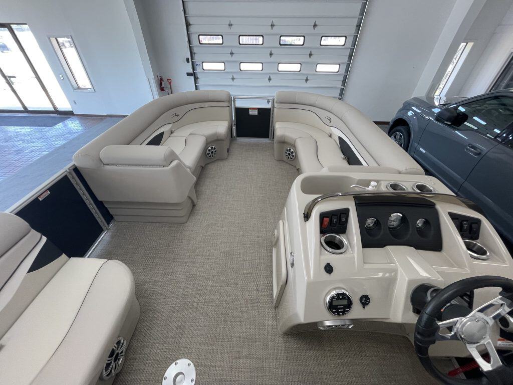 Interior view of a Bennington 21 SS pontoon boat with seating and control panel.