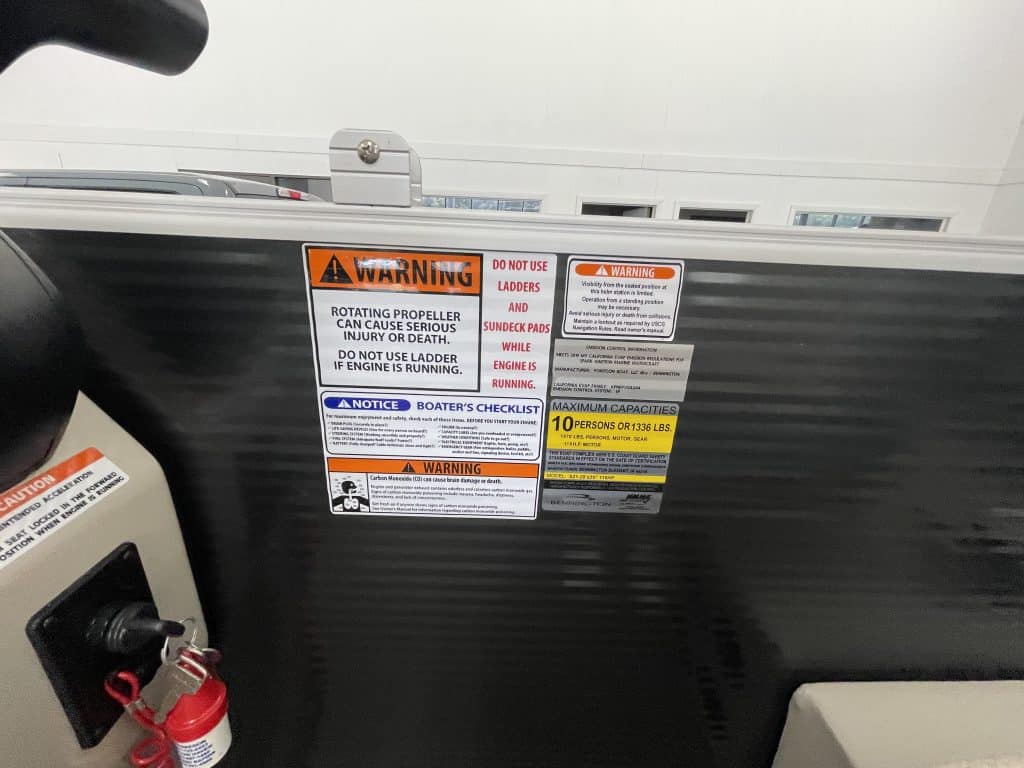 Boat safety warning labels on a Bennington 21 SSNPXAPG boat.