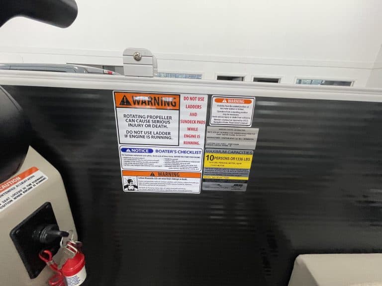 Boat safety warning labels on a Bennington 21 SSNPXAPG boat.