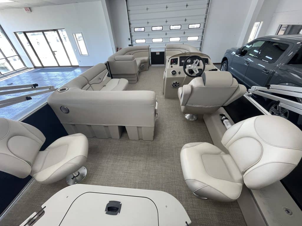 Luxury pontoon boat interior with seating and steering console.