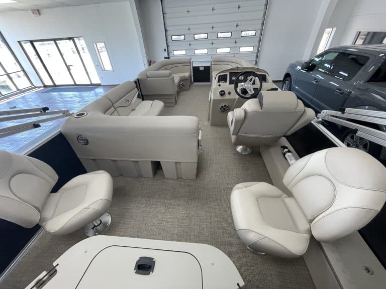 Luxury pontoon boat interior with seating and steering console.