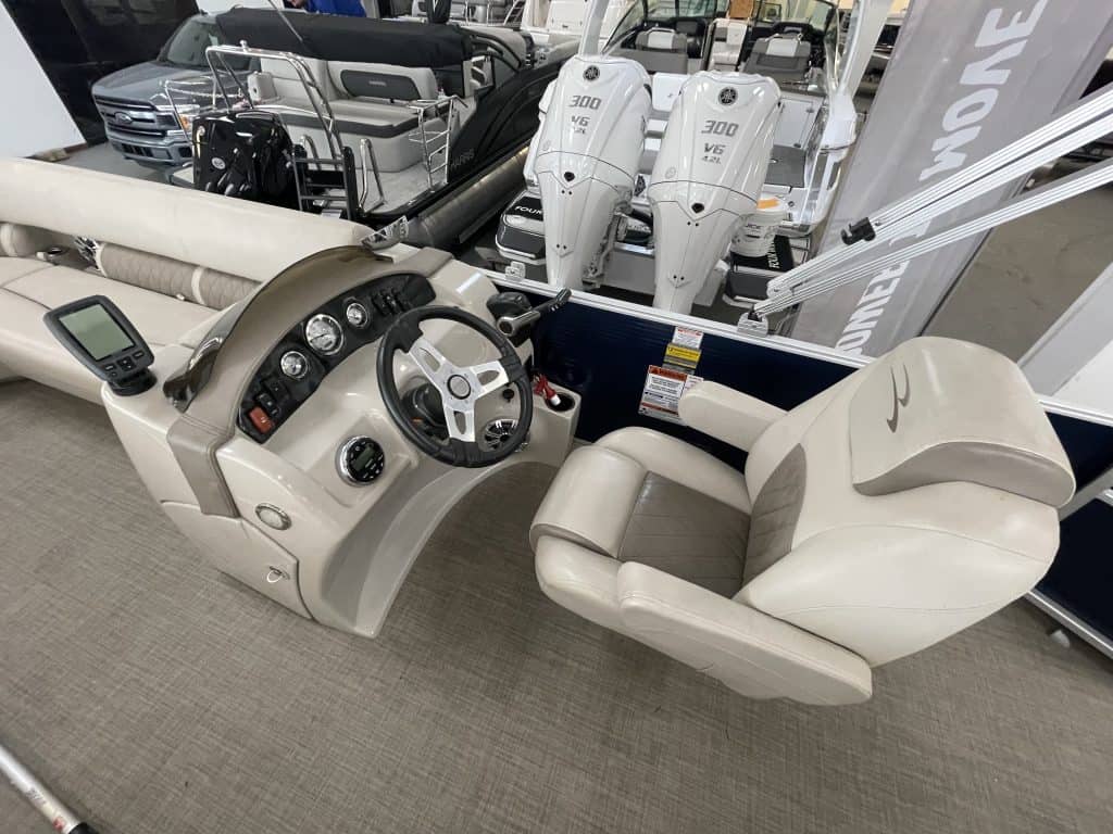 Boat helm with steering wheel and controls at Hall's Sport Center.