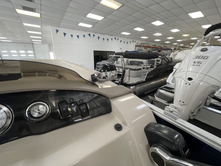 Bennington 21 SLX pontoon boat inside Hall's Sport Center.