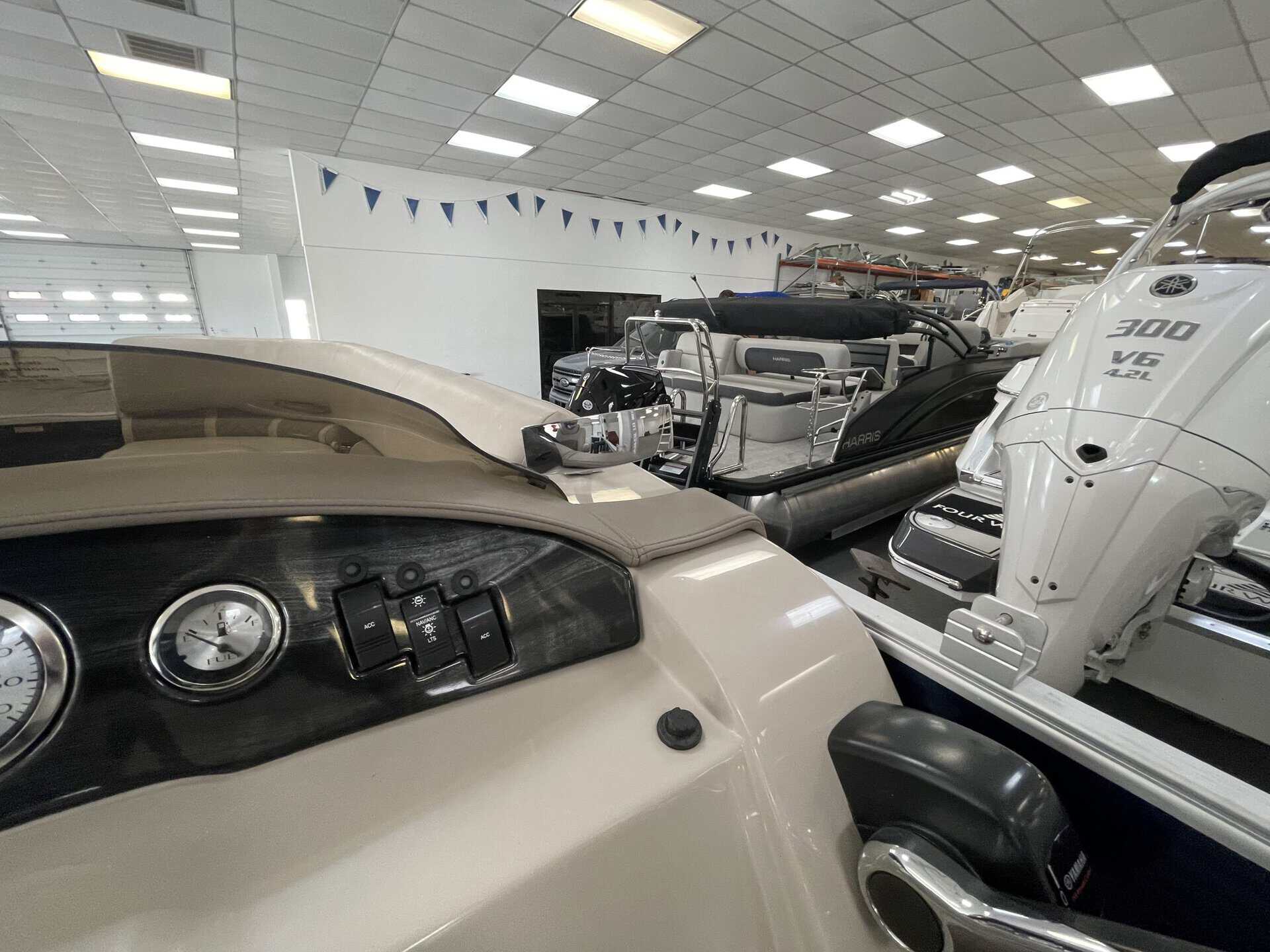 Bennington 21 SLX pontoon boat inside Hall's Sport Center.