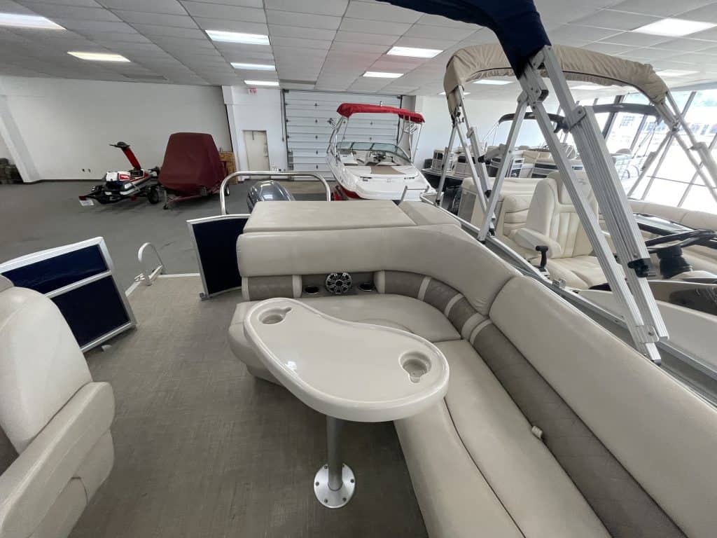 Indoor display of Bennington 21 SLX boat with seating and accessories.