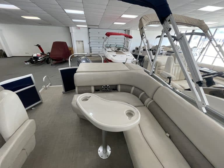Indoor display of Bennington 21 SLX boat with seating and accessories.