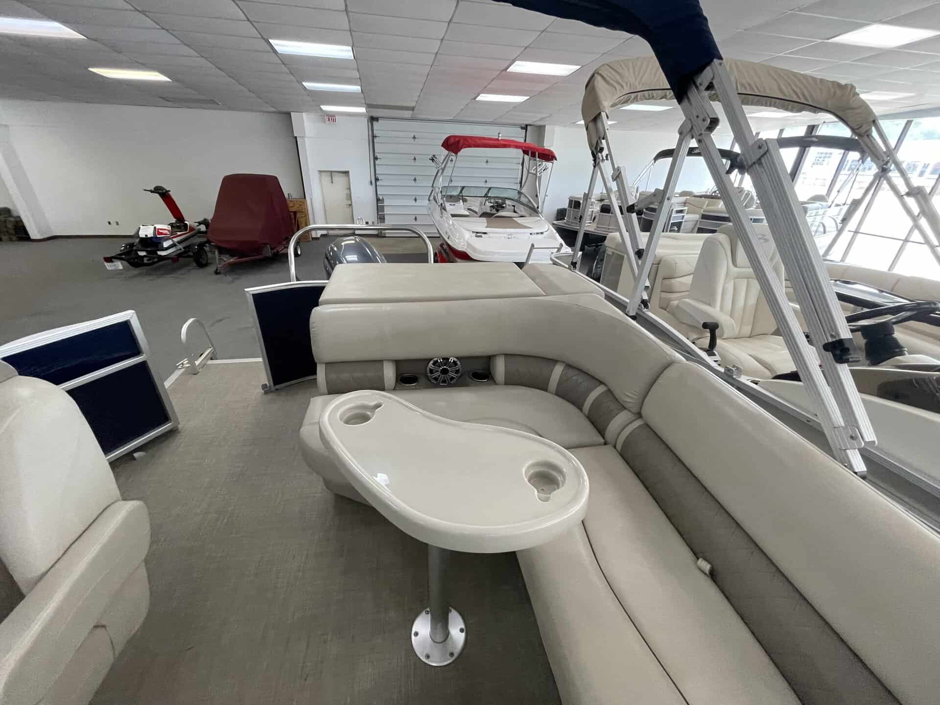 Indoor display of Bennington 21 SLX boat with seating and accessories.