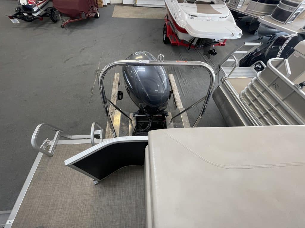 Bennington 21 SLX pontoon boat with outboard motor on display.