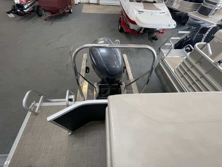 Bennington 21 SLX pontoon boat with outboard motor on display.