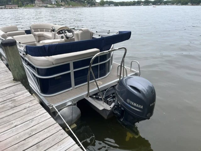 Bennington 21 SLX pontoon boat docked at the lake with Yamaha engine.
