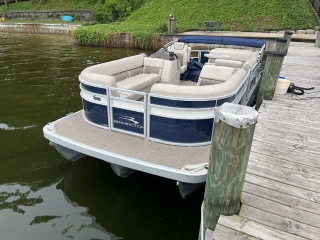 Bennington 21 SLX pontoon boat docked at Hall's Sport Center marina.