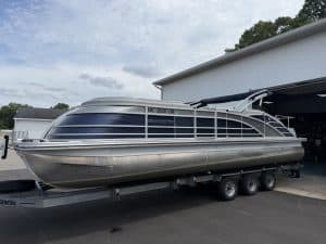 Bennington 25QSB pontoon boat on trailer at Hall's Sport Center.
