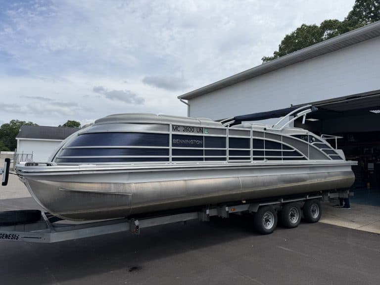 Bennington 25QSB pontoon boat on trailer at Hall's Sport Center.