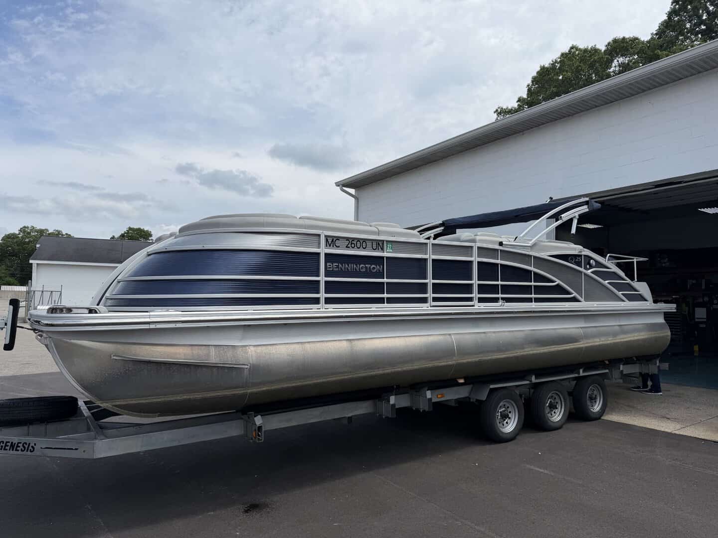 Bennington 25QSB pontoon boat on trailer at Hall's Sport Center.