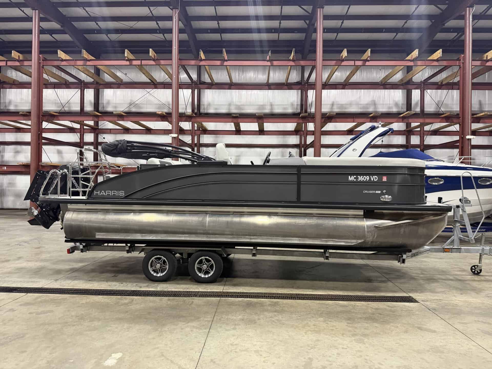 Harris 230 SBHL pontoon boat inside Hall's Sport Center.