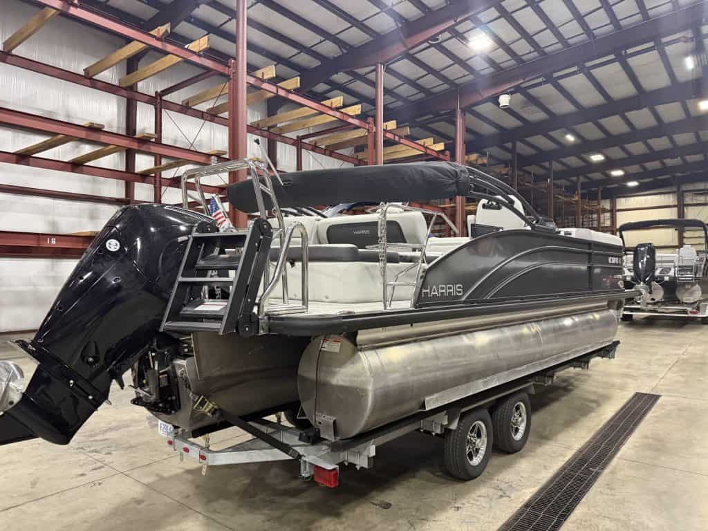 Harris 230 SBHL pontoon boat inside Hall's Sport Center.