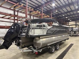 Harris 230 SBHL pontoon boat inside Hall's Sport Center.