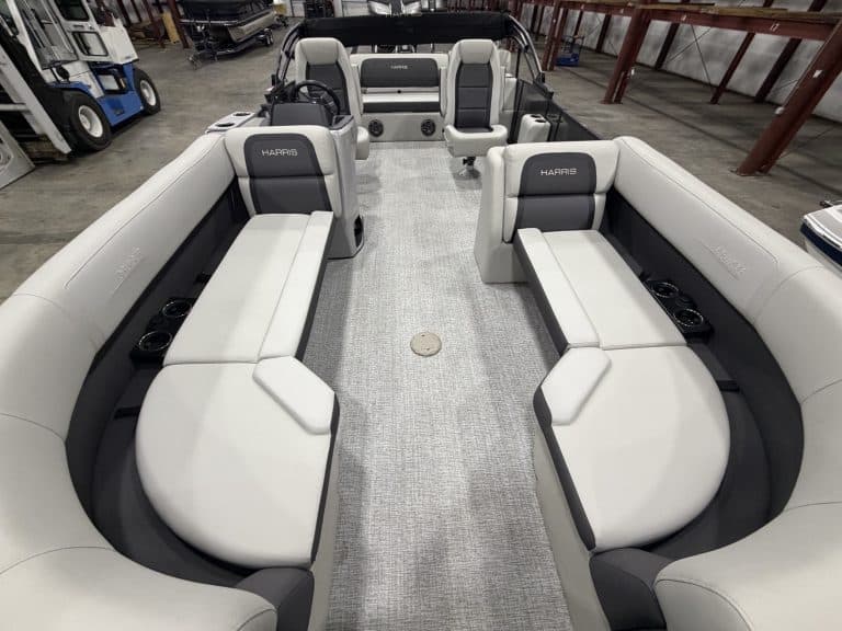 Interior view of Harris 230 SBHL pontoon boat with seating and steering console.