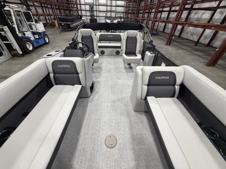 Harris 230 SBHL pontoon boat inside Hall's Sport Center showroom.