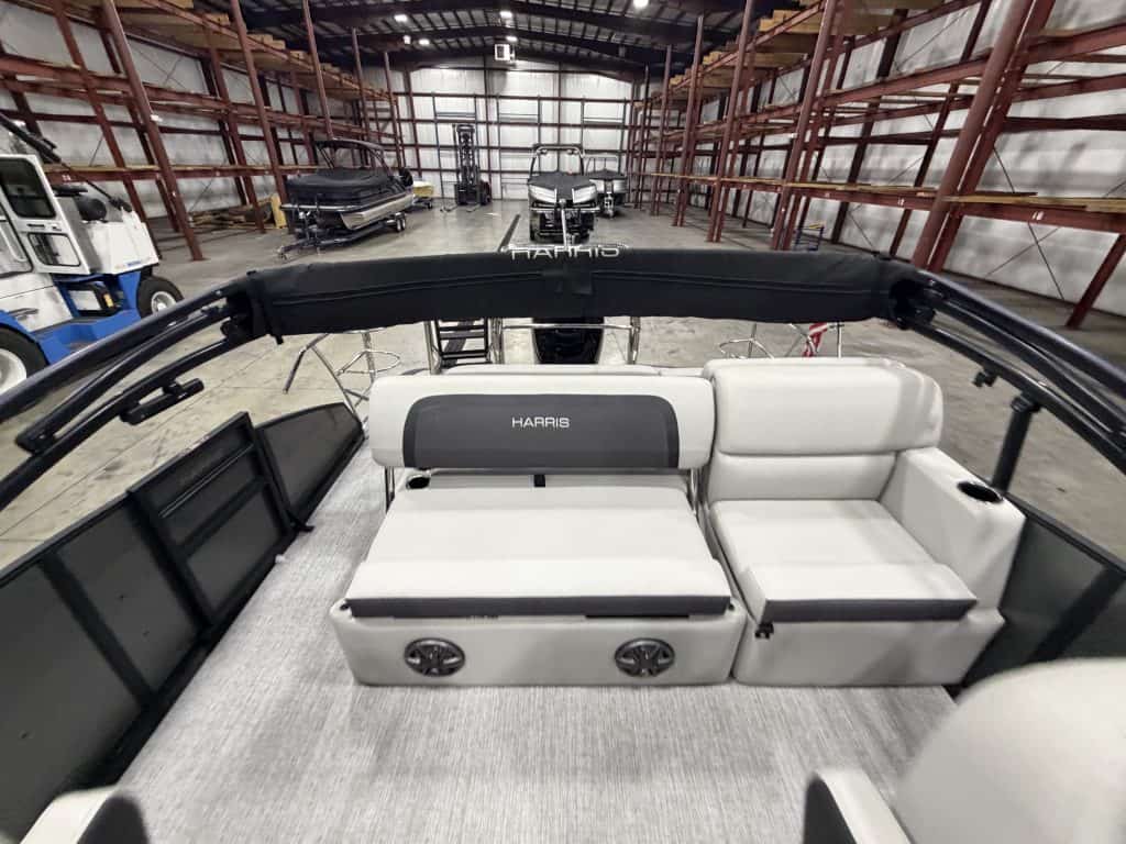 Interior view of Harris 230 SBHL pontoon boat with seating and speakers.