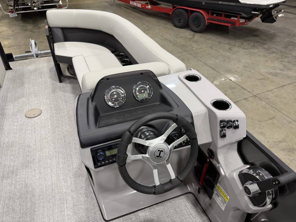 Boat control console with steering wheel and gauges at Hall's Sport Center.