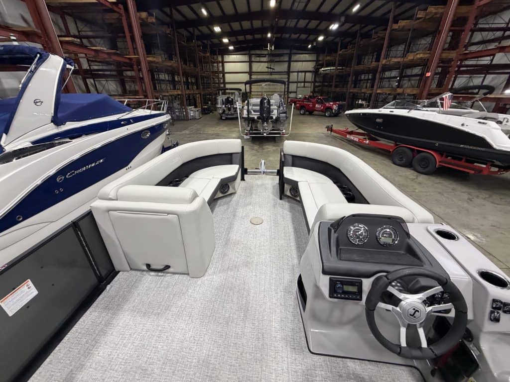 Indoor boat showroom at Hall's Sport Center with various boats and watercraft.