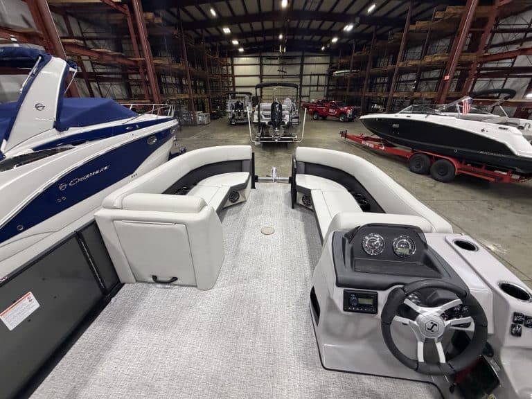 Indoor boat showroom at Hall's Sport Center with various boats and watercraft.