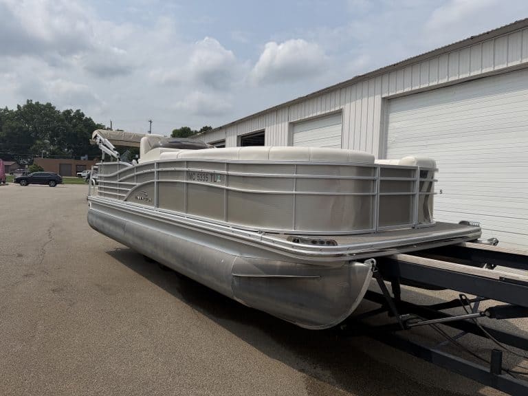 Bennington 2275 RL pontoon boat parked outside a building.