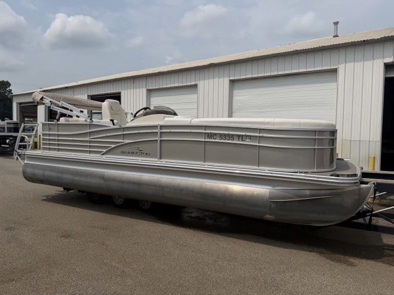 Bennington 2275 RL pontoon boat parked outside Hall's Sport Center.